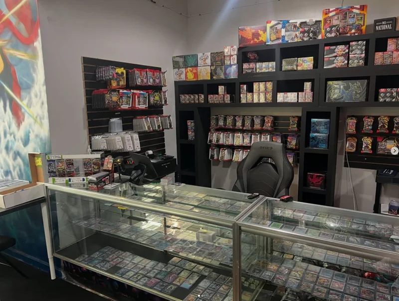 The front counter at Waterfront Card Shop, with graded singles in the display case and sealed product on the wall