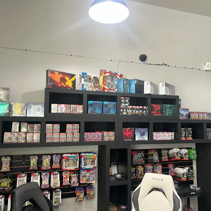 Shelves of Pokémon Elite Trainer Boxes, booster bundles and blister packs on the shop floor